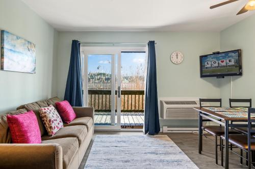 a living room with a couch and a table at Assateague Inn 105-S in Deep Hole