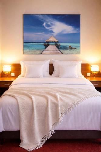 a bedroom with a white bed with a pier at Morska Fala in Pobierowo