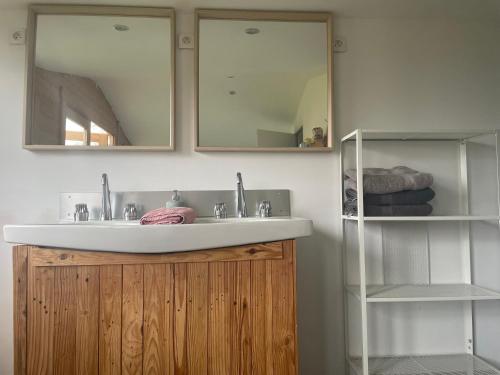 a bathroom with a sink and two mirrors at Yourte Volcans Puy de Dome in Montfermy