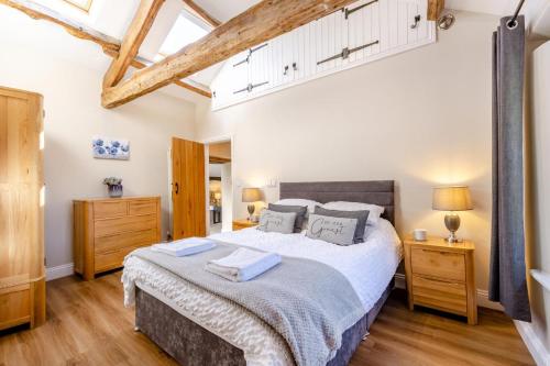 a bedroom with a large bed and wooden floors at 2 Bed in Penrith oc-87349 in Penrith