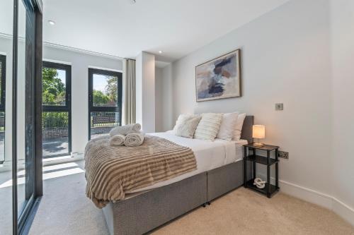 a bedroom with a bed and a large window at Spacious North London Flat Sleeps 4 in New Barnet