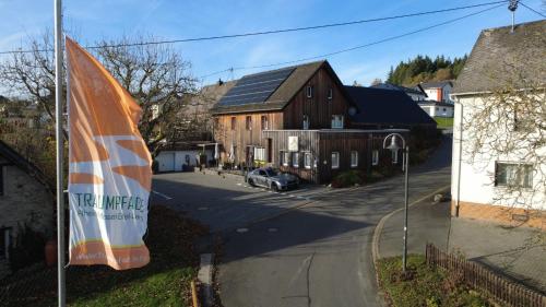 a view of a street with a house and a flag at Race & Rest Apartments in Baar