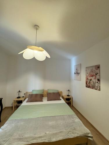 a bedroom with a large bed with a ceiling fan at Apartment Niko in Pakoštane