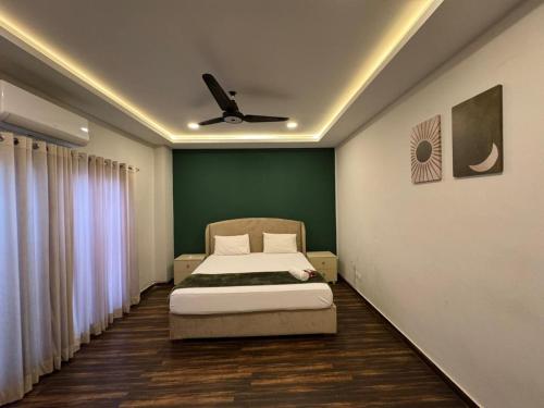 a bedroom with a bed and a ceiling fan at Executive 2 bedrooms in Rawalpindi - Self Checkin in Rawalpindi