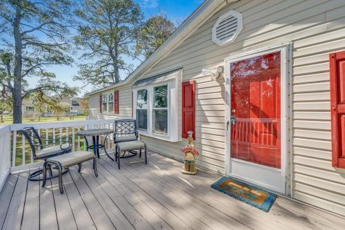 a wooden deck with a table and chairs on a house at Bayside Haven in Deep Hole
