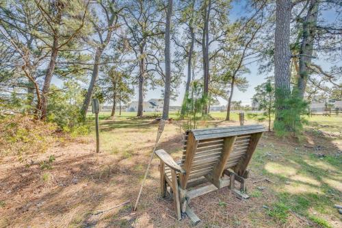 a wooden bench sitting in a park with trees at Bayside Haven in Deep Hole