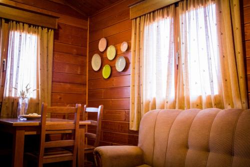 a living room with a couch and a table and window at Camping Oleiros in Oleiros