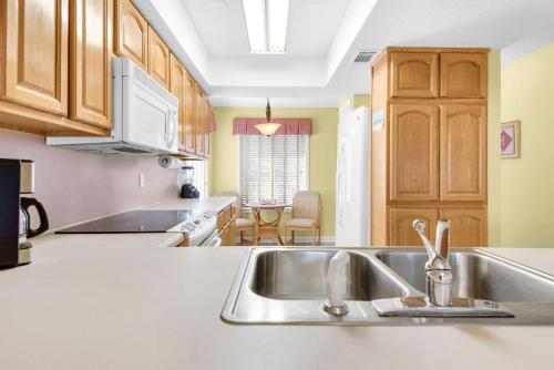 a kitchen with a sink and a counter top at Soundside Holiday Beach Resort in Pensacola Beach