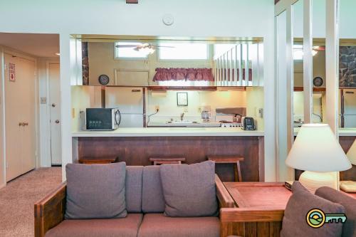 a living room with a couch and a kitchen at Aspen East Unit #131 in Basye
