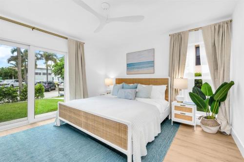 a bedroom with a large bed and a large window at The Beach Villa in Juno! 1-Steps to the Beach in Juno Beach