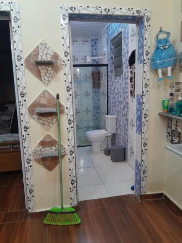 a bathroom with a mirror and a broom at Esteira in Iguape