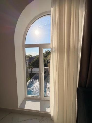 a window with a view of a swimming pool at Gabala Palm Villa in Gabala