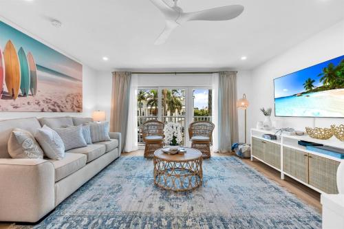 a living room with a couch and a tv at ON The Beach Juno! 3-Top Rated Villa! in Juno Beach