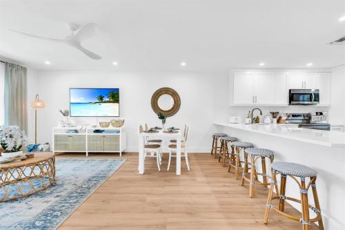 a kitchen and living room with a table and chairs at ON The Beach Juno! 3-Top Rated Villa! in Juno Beach