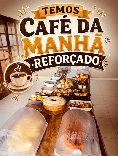 a table with various pastries and cups of coffee at Marina's Pousada in Pasto da Mata