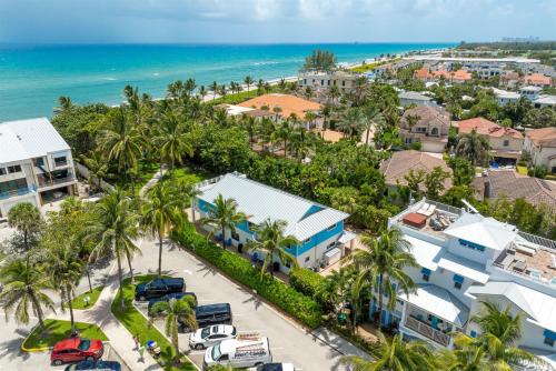 an aerial view of a resort with palm trees and the ocean at Juno Beach Seaside Escape I Steps from the Ocean! in Juno Beach