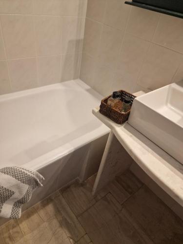 a bathroom with a bath tub and a sink at Nicolas Luxury Apartment in Amalias