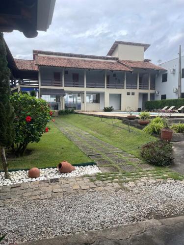 a building with a yard with two balls on the ground at Marina's Pousada in Pasto da Mata