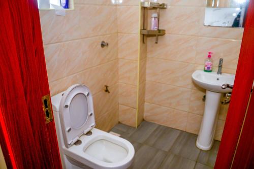 a bathroom with a toilet and a sink at BA STADEVIEW WEST STUDIOs in Nairobi