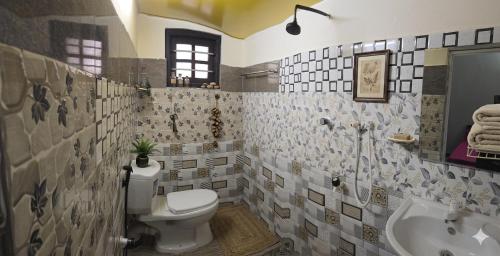 a bathroom with a toilet and a sink at Beach Guest House Addalaichenai in Addalachenai