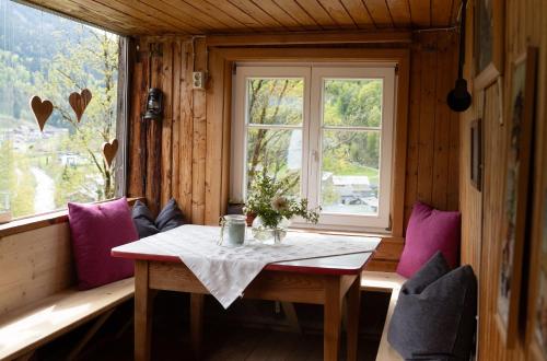 a dining room with a table and a window at Berghaus Antonia in Mellau