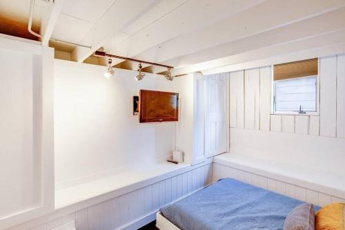 a white room with a bed and a window at Cozy Bungalow 7 Blocks from ND Campus in South Bend