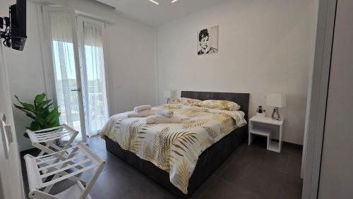 a bedroom with a bed and a table and a chair at Forte2110 in Misano Adriatico