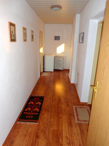 a hallway with a hard wood floor and a door at Penzión Gardoš in Kežmarok