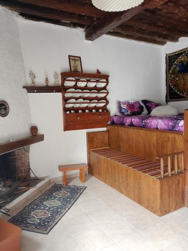 a living room with a bed and a fireplace at sevas'view in Émbonas