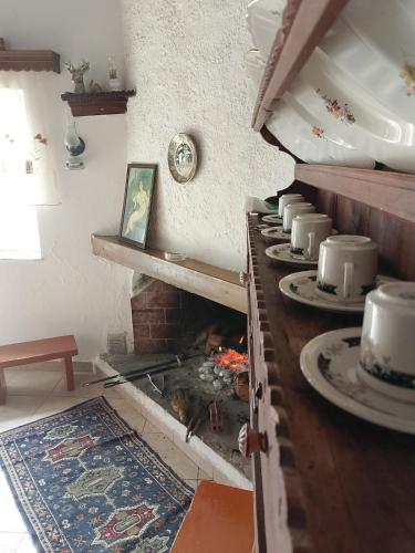 a kitchen with a fireplace with plates on it at sevas'view in Émbonas