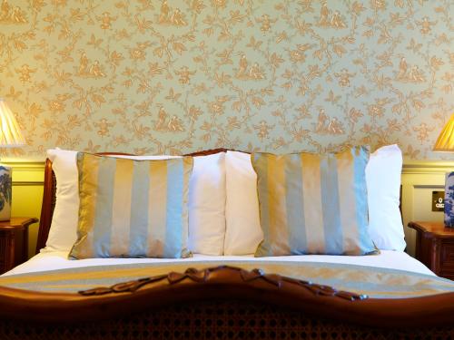 a bedroom with a bed with two pillows at The Wrea Head Hall Country House Hotel & Restaurant in Scarborough
