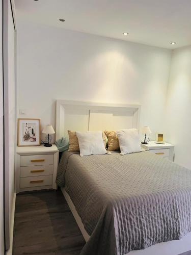 a bedroom with a large bed with two night stands at El Olivo Verde 2 in Jaén