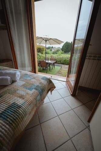 a bedroom with a bed and a table with an umbrella at Orli Home e Relax in Casole dʼElsa