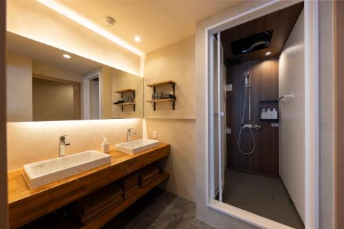 a bathroom with a sink and a shower at ホテル雅々音 in Sasebo
