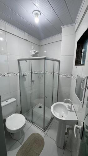 a bathroom with a shower and a toilet and a sink at Ed Odilon Vieira 104 in Vitória da Conquista