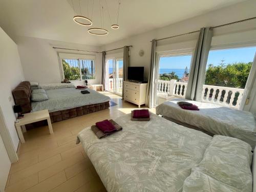 a bedroom with two beds and a balcony at Marbella Villa 16 Persons -Pool in Marbella