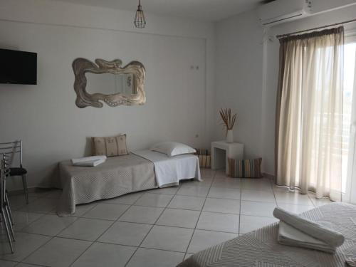 a room with two beds and a mirror on the wall at Niko's apartments 2 in Elafonisos