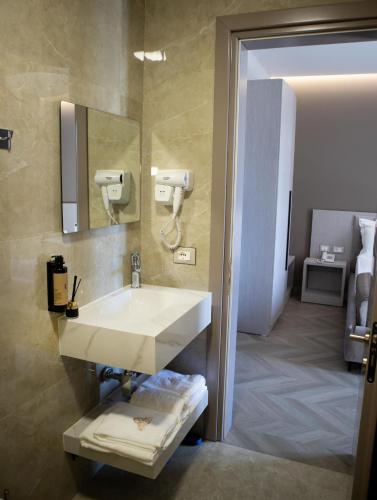 a bathroom with a sink and a mirror at Rodi Hotel Elbasan in Elbasan