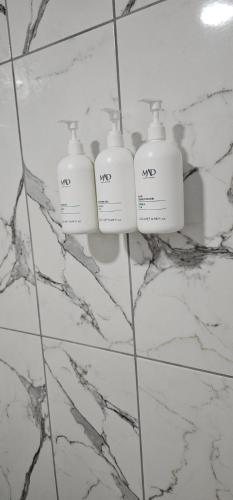 a bathroom with two soap bottles on a wall at MOY Beldibi Hotel in Antalya