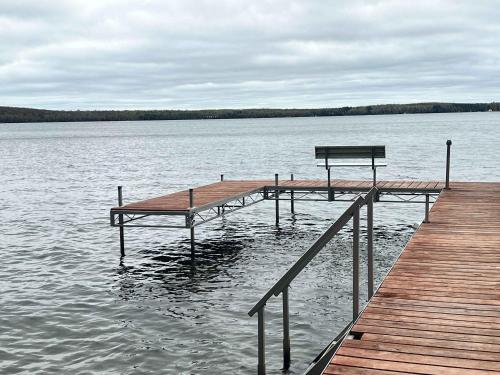 a wooden dock with a bench on the water at American Eagle Retreat in Conover