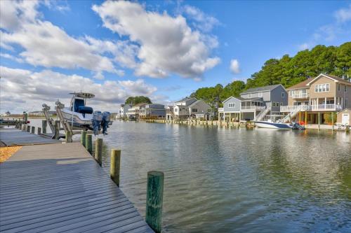 a boat is docked at a dock next to houses at Coastal Crab in Greenbackville