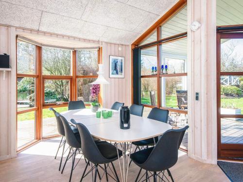 a dining room with a table and chairs at 4 star holiday home in Ulfborg in Ulfborg