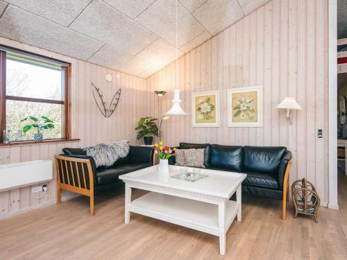 a living room with a couch and a table at 4 star holiday home in Ulfborg in Ulfborg