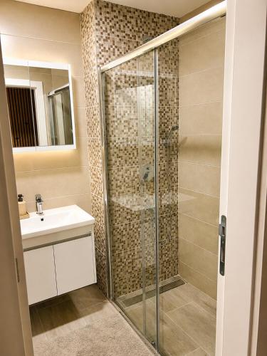a bathroom with a shower and a sink at Veles in Banja Koviljača