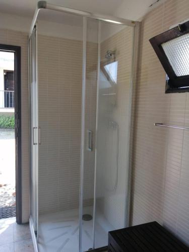 a shower with glass doors in a bathroom at Casa D'Afife in Afife