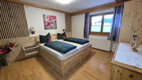 a bedroom with a bed and a sink in it at Apart-Alpenglück in Biberwier