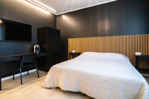 a bedroom with a bed and a desk and a television at Casa Di Luca in Chioggia