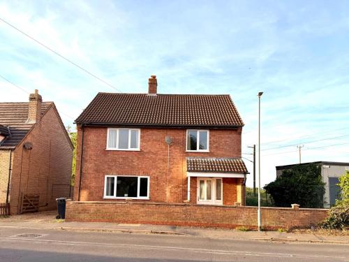 a brick house on the side of a street at Swan View House in Littleport
