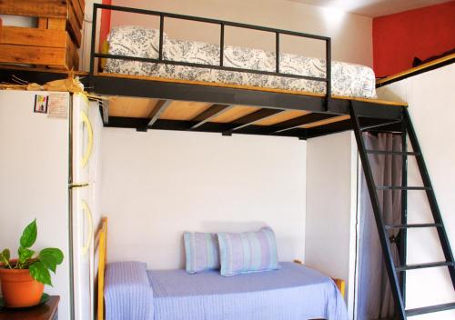 a bunk bed in a room with a bunk bed in a room at LOFT Huayna picchu in La Falda