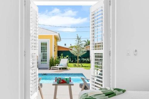 a view of a pool from the living room of a house at The Luxe Sunshine Villa w Private Pool House in West Palm Beach